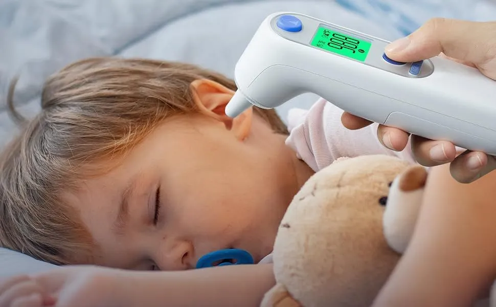 Parent checking a baby’s temperature with a Viproud no-touch thermometer